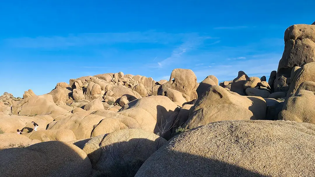 People walking across large rocks