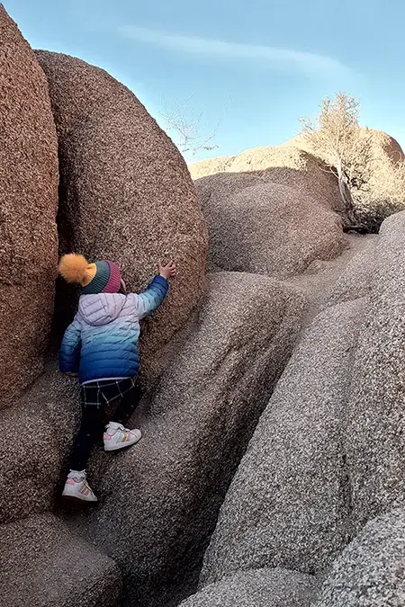 Child climbing the rocks