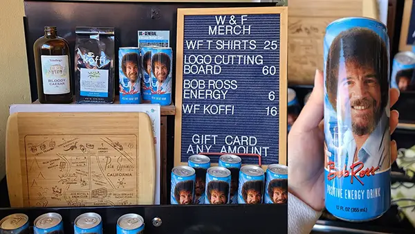 Mini stand with Bob Ross drinks and merchandise