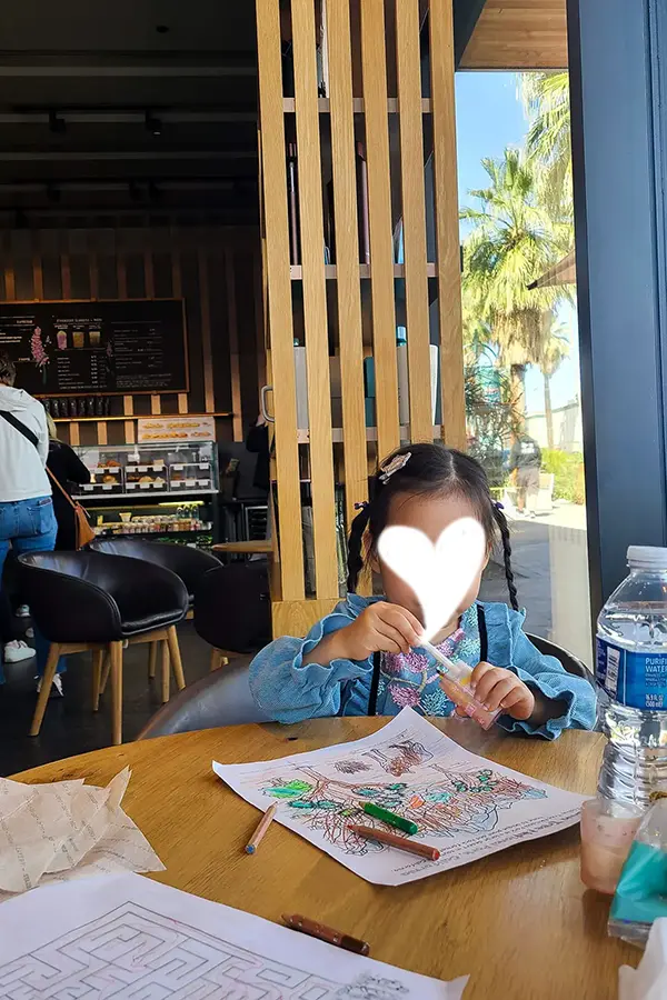 Ellie coloring a Joshua Tree picture at Starbucks