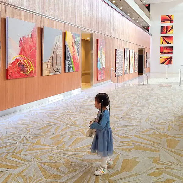 Exhibition-style paintings in the hotel lobby, reminiscent of an art museum